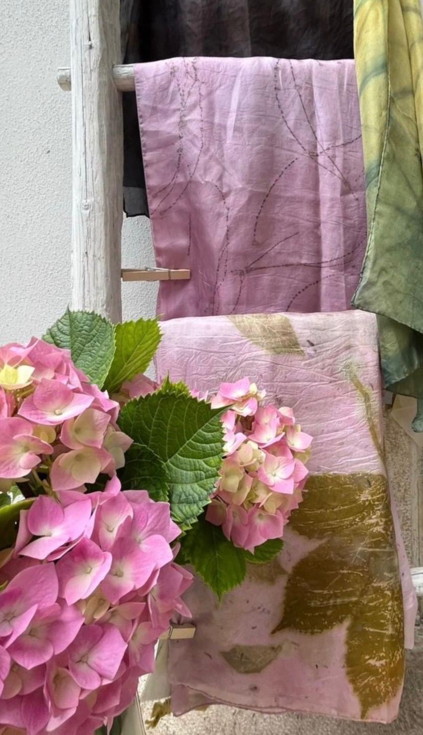 Foulard in seta stampati a ecoprint stesi su una scala di legno, fra le ortensie del giardino dell'atelier di Arco