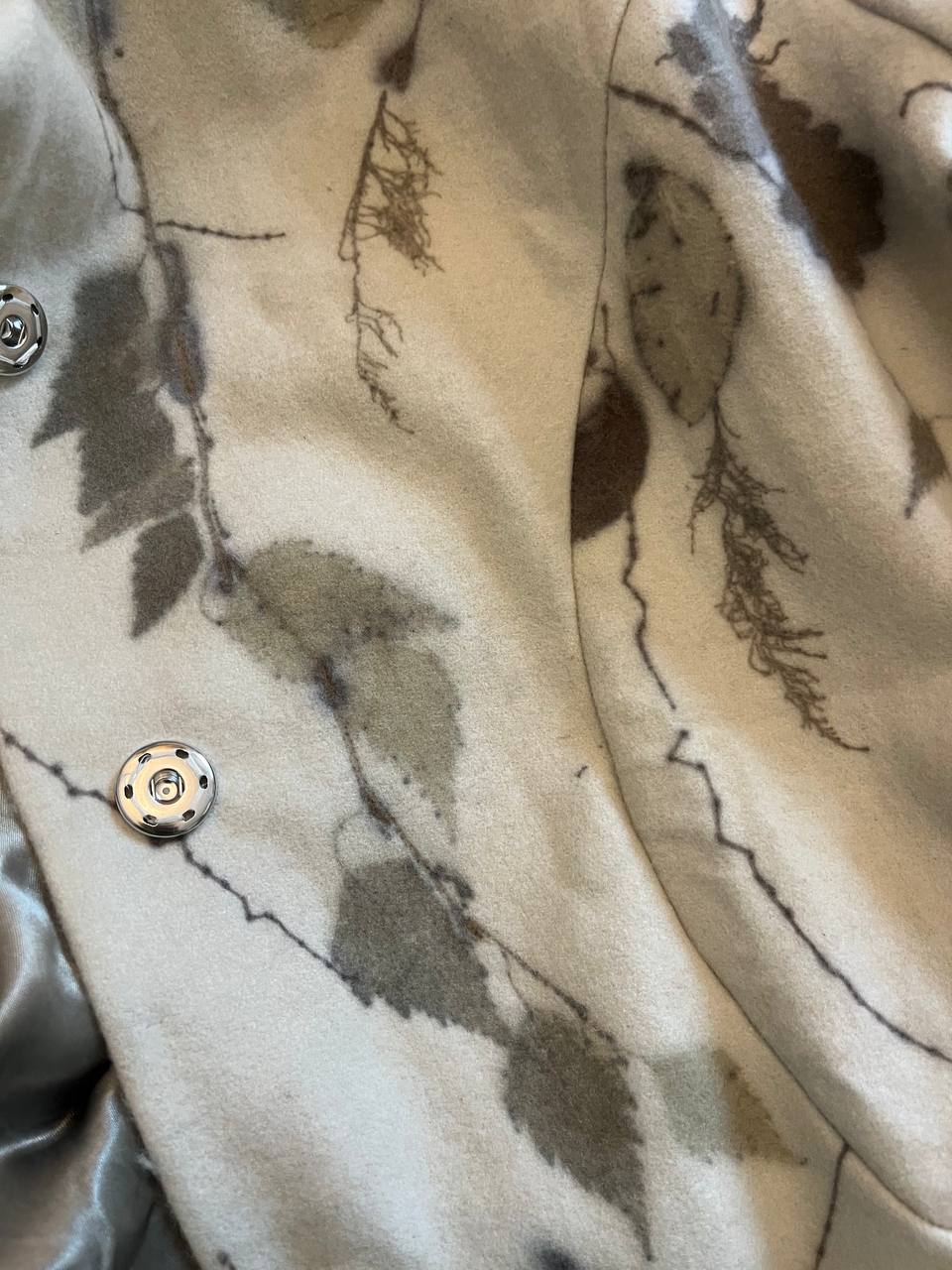The press studs down the front and the satin lining, close up