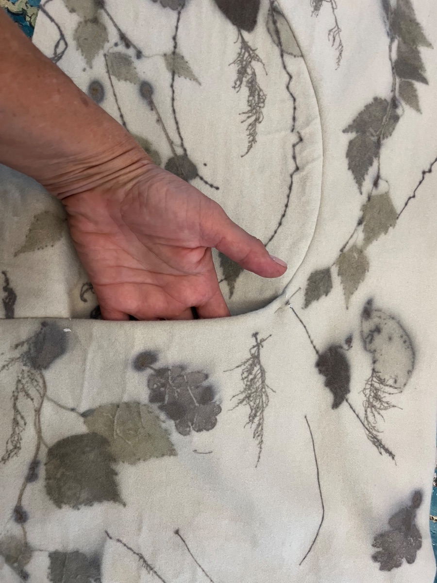 The pocket set into the dart, with a hand inside